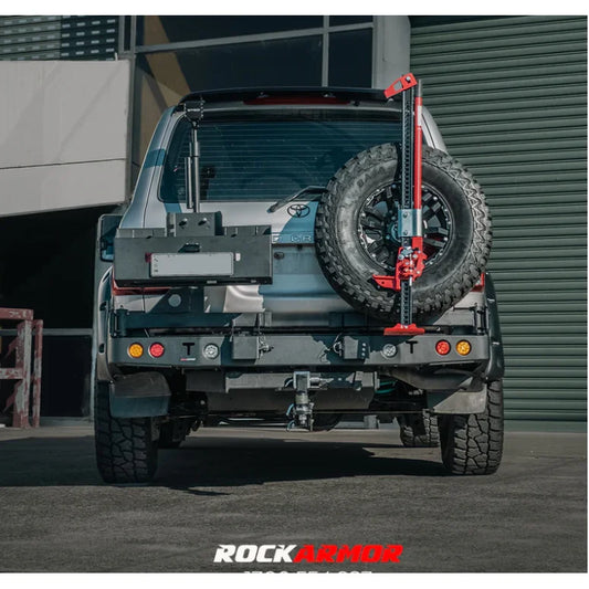 Rear view of silver toyota landcruiser fj105 with rockarmor steel dual wheel carrier and rear-mounted spare tire jack