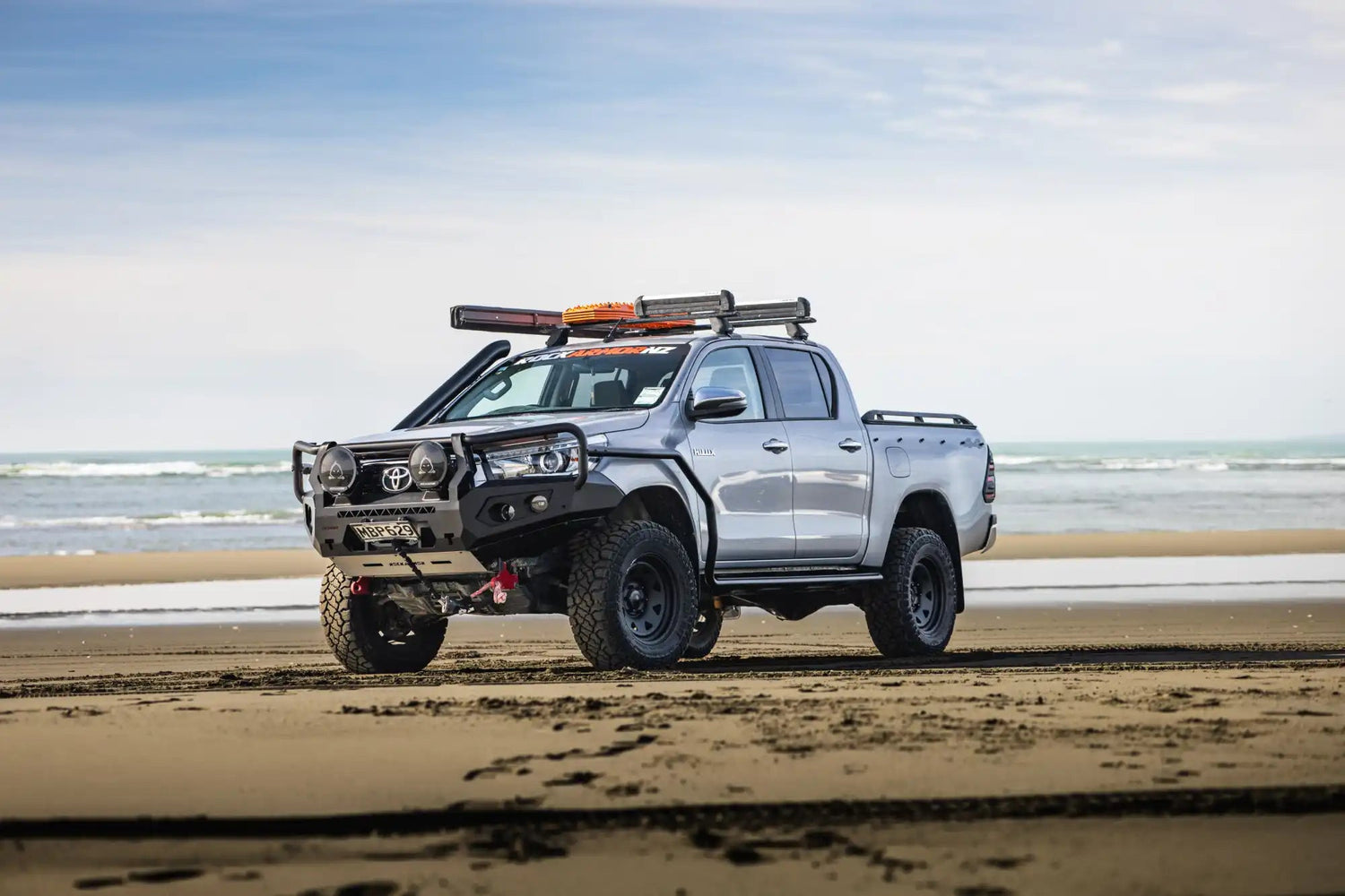 Silver off-road pickup truck.