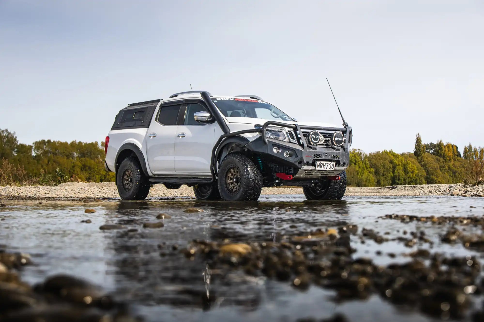 White Nissan Navara pickup truck.