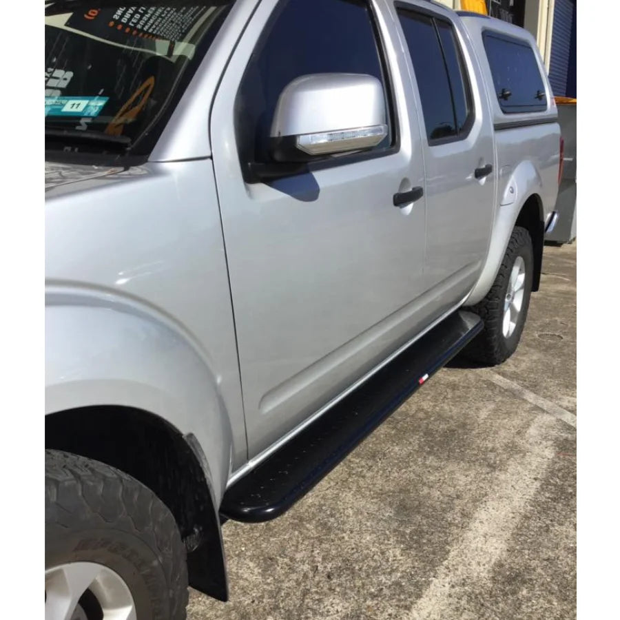 Silver Nissan Navara pickup with black brush bars and premium steel Rockarmor Brushbar