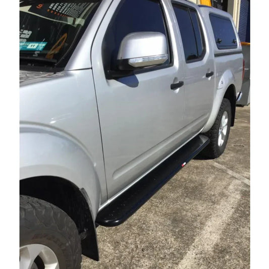 Silver pickup truck featuring rockarmor rockslider brushbar with black running boards for nissan navara d40 2005-2015