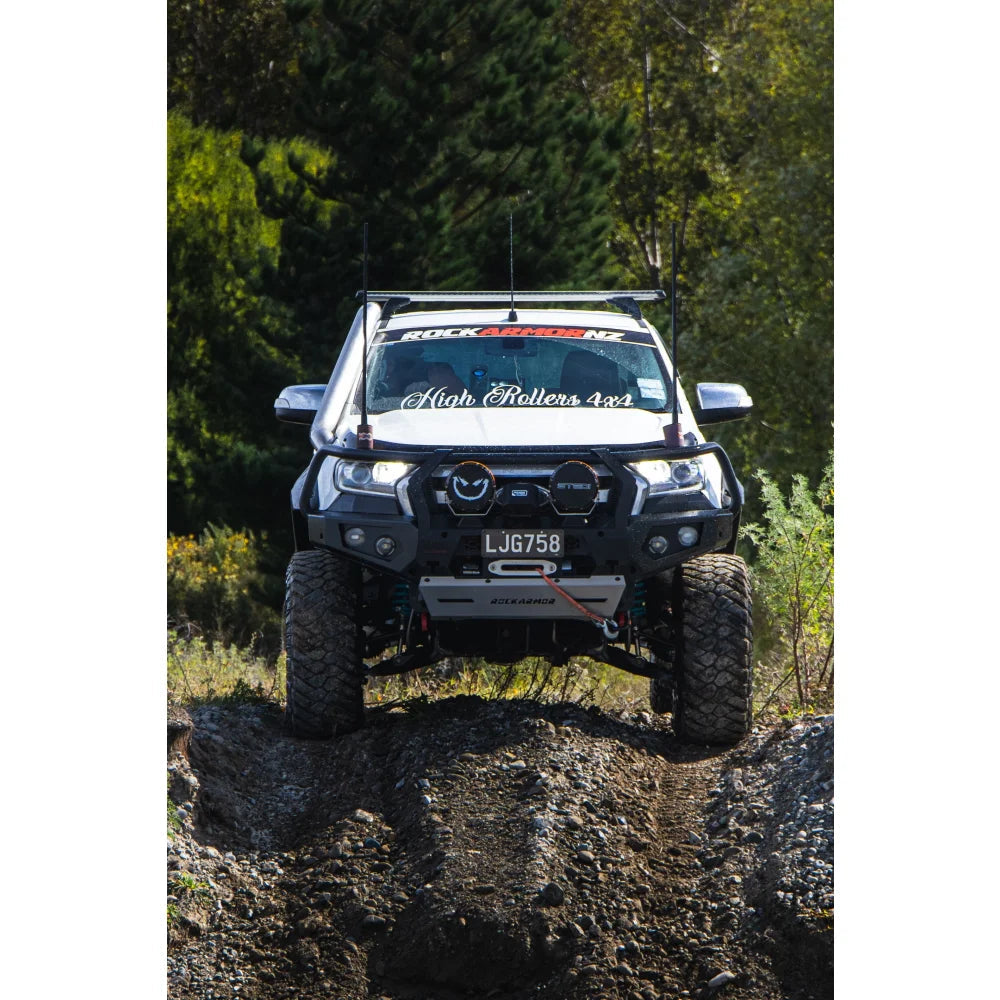 White off-road truck with Rockarmor GT Steel Hoop Bullbar featuring driving lights and fog lights