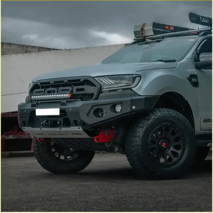 Gray ford ranger with rugged black off-road tires roof rack and rockarmor gt hoopless bullbar rock sliders