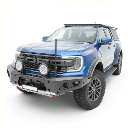 Blue ford ranger raptor with black front bumper and roof rack featuring rockarmor gt hoopless bullbar and rock sliders