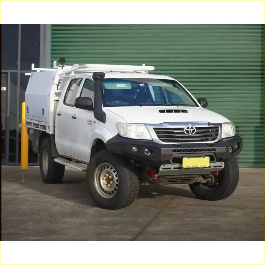 White toyota hilux pickup with black gt hoopless bullbar roof rack and rock sliders from rockarmor rock pack