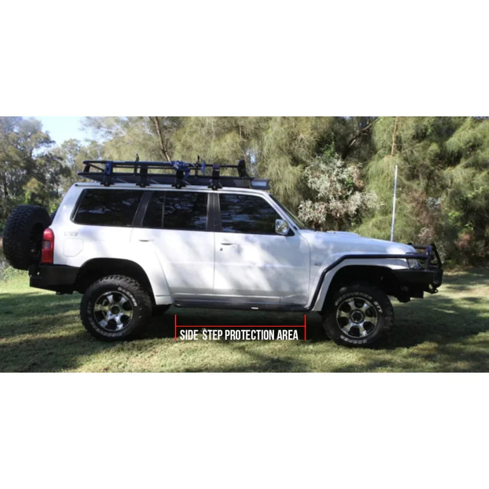 White nissan patrol y61 with rockarmor steel rockslider side steps and roof rack suited for off-road use