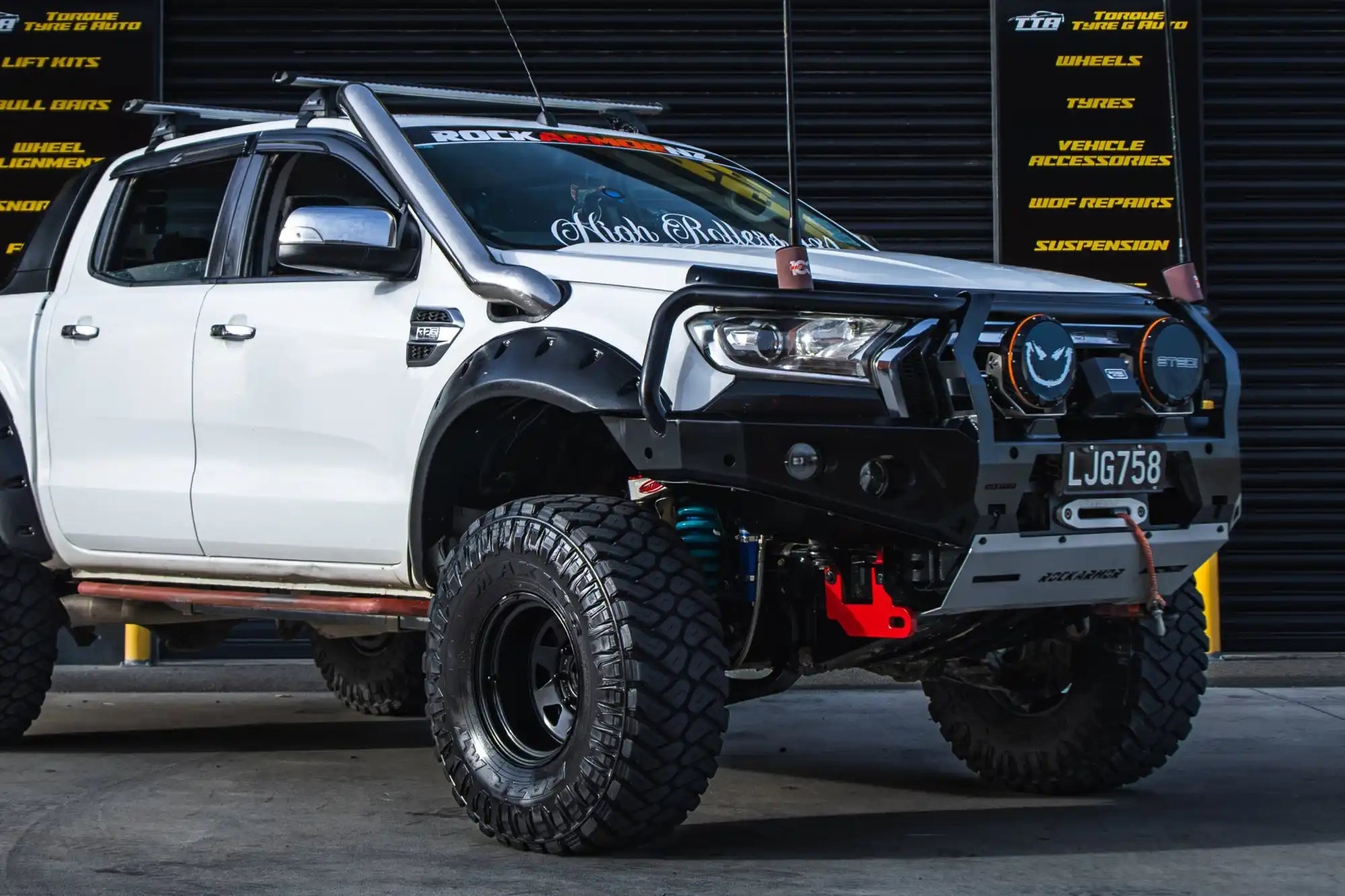 White off-road pickup truck.